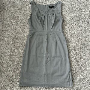 Light gray sleeveless business dress. Pleating detail on neck. Fully lined.